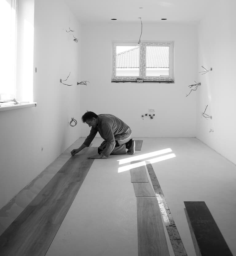 Flooring professional installing plank flooring